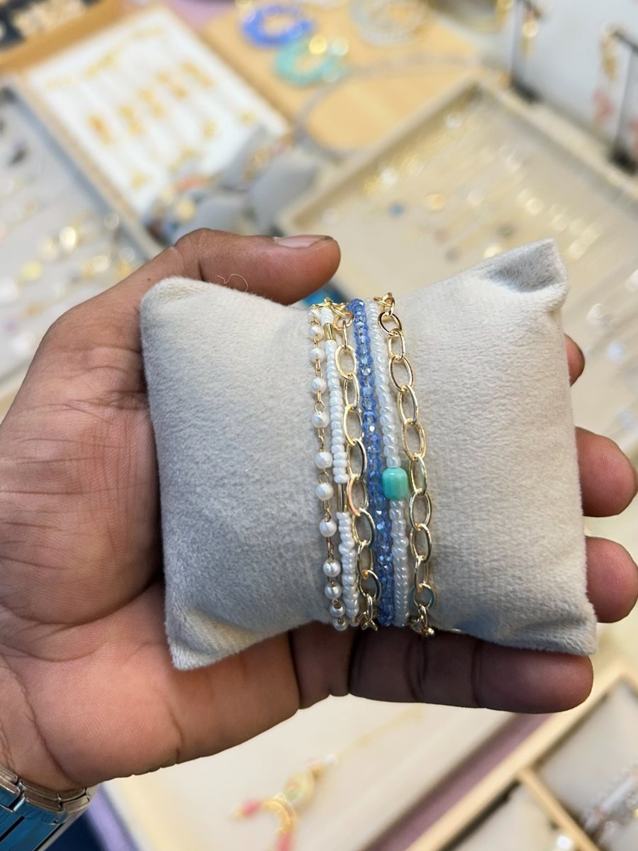 Stack of pearl and crystal bracelets